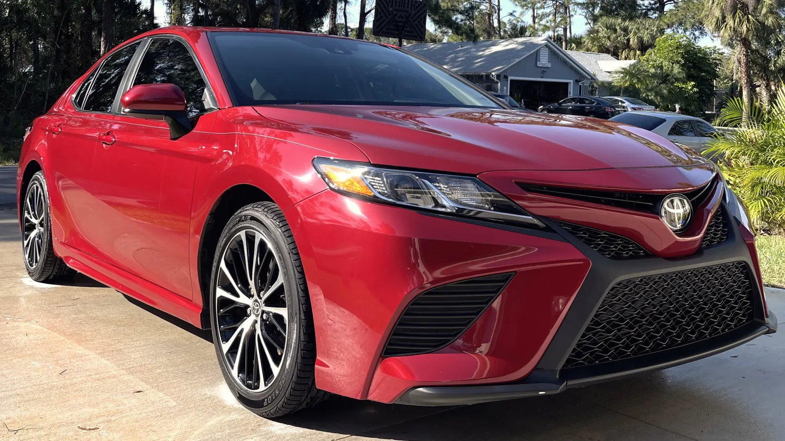 Red Toyota Camry after a full detail, parked in a driveway