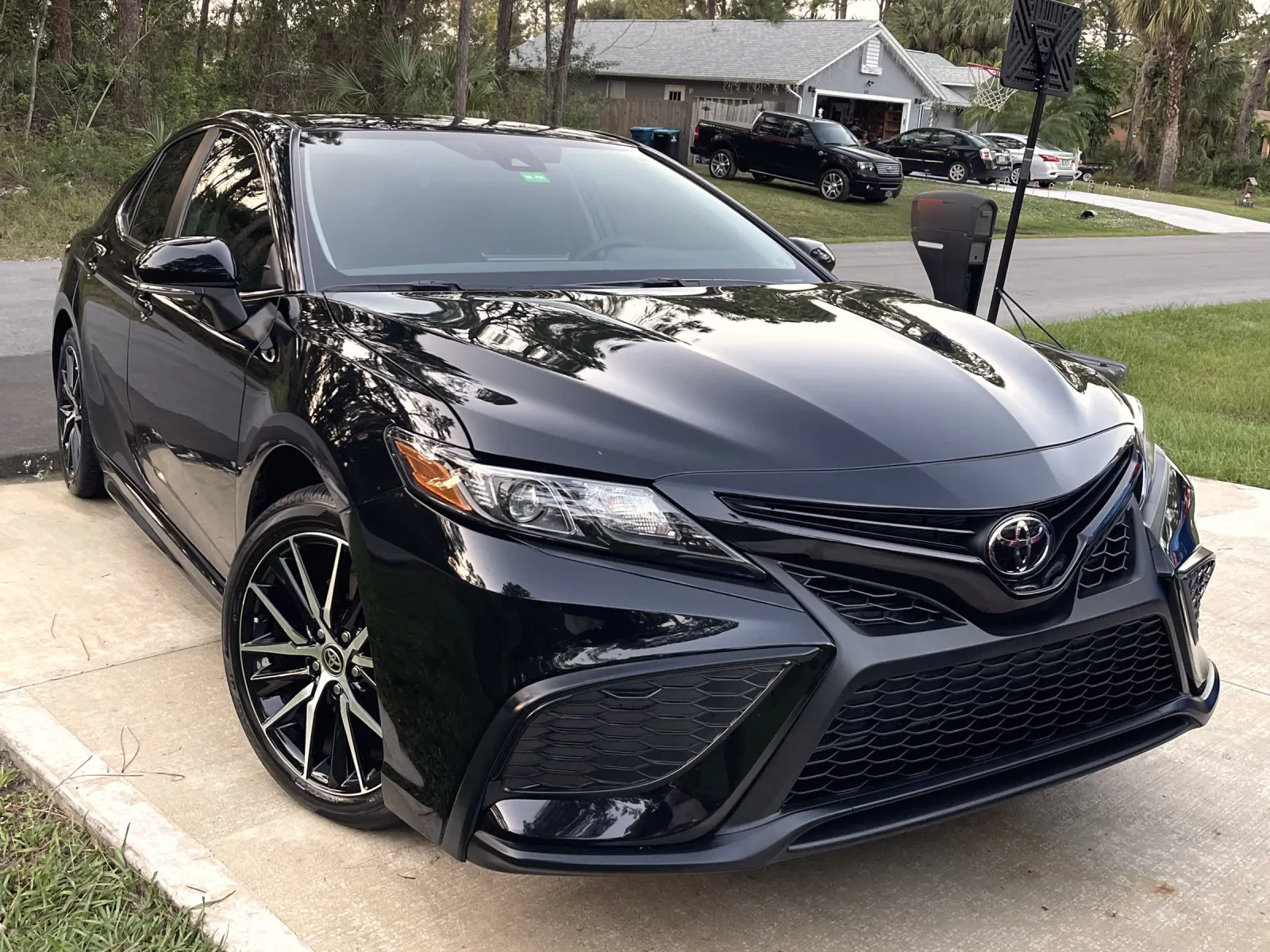 Black Toyota Camry after a detail and paint work, front three-quarter view
